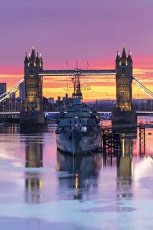 Tower Bridge and HMS Belfast reflecting in a still River Thames at sunset, London, England, United Kingdom, Europe Tower Bridge and HMS Belfast reflecting in a still River Thames at sunset, London, England, United Kingdom, Europe