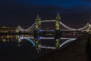 Tower Bridge at night just before sunrise, reflecting in a still River Thames, London, England, United Kingdom, Europe Tower Bridge at night just before sunrise, reflecting in a still River Thames, London, England, United Kingdom, Europe