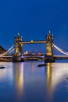 Tower Bridge at sunset with Canary Wharf skyline in background, London, England, United Kingdom, Europe Tower Bridge at sunset with Canary Wharf skyline in background, London, England, United Kingdom, Europe