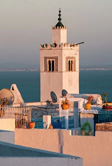 Tunis Collection: Tower and rooftops of Sidi Bou Said at sunset in front of the Mediterranean, Tunis, Tunisia