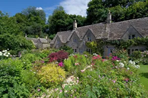 Traditional Cotswold stone cottages with colourful flower gardens, Bibury Traditional Cotswold stone cottages with colourful flower gardens, Bibury