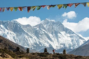 Cloudy Gallery: A trekker on their way to Everest Base Camp, Mount Everest is the peak to the left