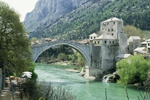 The Turkish Bridge over the River Neretva dividing the town, Mostar, Bosnia The Turkish Bridge over the River Neretva dividing the town, Mostar, Bosnia