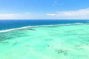 Turquoise coral reef meeting the blue Indian Ocean, aerial view by drone, Ile Aux Cerfs Turquoise coral reef meeting the blue Indian Ocean, aerial view by drone, Ile Aux Cerfs