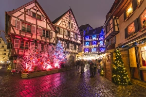 Typical houses enriched by Christmas ornaments and lights at dusk, Colmar, Haut-Rhin department Typical houses enriched by Christmas ornaments and lights at dusk, Colmar, Haut-Rhin department