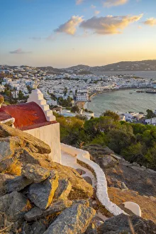 View of chapel and town from elevated view point at sunset, Mykonos Town, Mykonos View of chapel and town from elevated view point at sunset, Mykonos Town, Mykonos