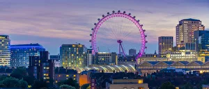 View of the London Eye and rooftop of Waterloo Station at dusk, Waterloo, London, England View of the London Eye and rooftop of Waterloo Station at dusk, Waterloo, London, England