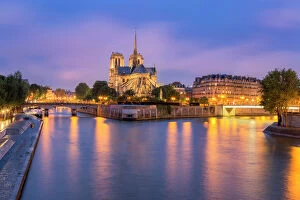 Traditionally French Gallery: View of Notre Dame de Paris and its flying buttresses across the River Seine at blue hour