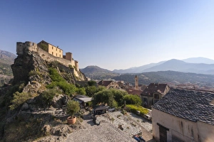 View of the old town of citadel of Corte perched on the hill surrounded by mountains View of the old town of citadel of Corte perched on the hill surrounded by mountains