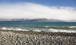 View from rocky shoreline across the stormy waters of Lake Pukaki, near Twizel, Mackenzie district View from rocky shoreline across the stormy waters of Lake Pukaki, near Twizel, Mackenzie district