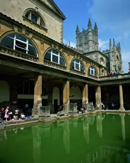 Bath Gallery: Visitors in the Roman Baths, with the Abbey beyond in Bath, UNESCO World Heritage Site