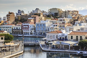 Voulismeni Lake, pedestrianised lakeside with cafes and Agios Nikolaos town, Lasithi Voulismeni Lake, pedestrianised lakeside with cafes and Agios Nikolaos town, Lasithi