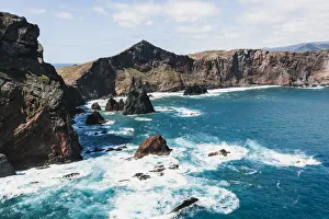 Waves of the Atlantic Ocean crashing on rocky cliffs, Sao Lourenco Peninsula, Canical Waves of the Atlantic Ocean crashing on rocky cliffs, Sao Lourenco Peninsula, Canical