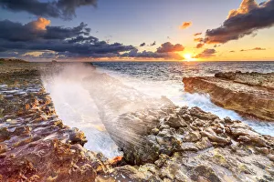 Waves crashing on cliffs at sunrise, Devils Bridge, Antigua, Antigua and Barbuda Waves crashing on cliffs at sunrise, Devils Bridge, Antigua, Antigua and Barbuda