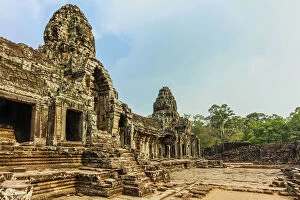 Cambodian Culture Collection: West inner gallery towers and four of the 216 carved faces at Bayon temple in Angkor