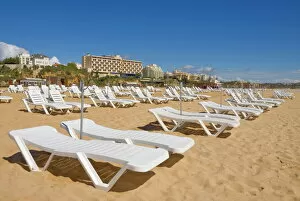 Related Images Gallery: Empty white sun lounger sunbeds on Praia da Rocha beach, Portimao, Algarve