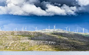 Wind farm of white turbines on rocky coastline, Troms county, Norway, Scandinavia, Europe Wind farm of white turbines on rocky coastline, Troms county, Norway, Scandinavia, Europe