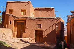 Winding lanes and donkey in 1500 year old traditional village of red mud brick houses Winding lanes and donkey in 1500 year old traditional village of red mud brick houses