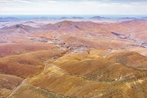 Winding road in the desert landscape from Mirador del Risco de las Penas viewpoint Winding road in the desert landscape from Mirador del Risco de las Penas viewpoint