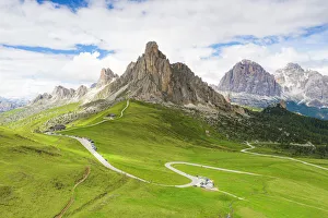 Winding road of Giau Pass in the green landscape with Ra Gusela Winding road of Giau Pass in the green landscape with Ra Gusela