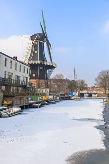 Windmill De Adriaan along the frozen canal of Spaarne river, Haarlem, Amsterdam district Windmill De Adriaan along the frozen canal of Spaarne river, Haarlem, Amsterdam district