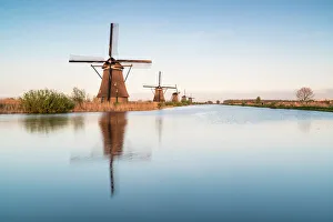 Windmills in a row on the canal, Kinderdijk, UNESCO World Heritage Site, Molenwaard municipality Windmills in a row on the canal, Kinderdijk, UNESCO World Heritage Site, Molenwaard municipality