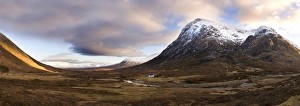 Winter panoramic view of Rannoch Moor showing lone whitewashed cottage on the bank of a river