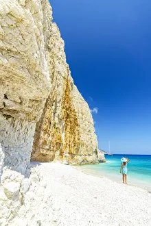 Woman admiring the white limestone cliffs standing on Fteri Beach, Kefalonia, Ionian Islands, Greek Islands, Greece Woman admiring the white limestone cliffs standing on Fteri Beach, Kefalonia, Ionian Islands, Greek Islands, Greece