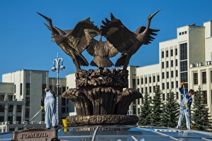 Woman cleaning a giant bird statue on top of a glass cupola on Nezalezhnasti Independence square, Minsk, Belarus Woman cleaning a giant bird statue on top of a glass cupola on Nezalezhnasti Independence square, Minsk, Belarus