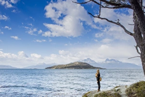 Woman looking out over the Magellan Straits and Darwin Mountain range in Tierra del Woman looking out over the Magellan Straits and Darwin Mountain range in Tierra del