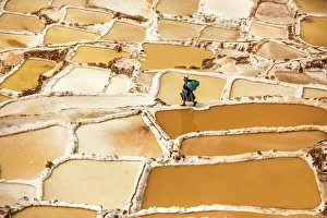 Woman mining salt, Salineras de Maras, Maras Salt Flats, Sacred Valley, Peru, South Woman mining salt, Salineras de Maras, Maras Salt Flats, Sacred Valley, Peru, South