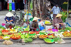 Women selling vegetables at the central market in Hoi An, Quang Nam Province, Vietnam Women selling vegetables at the central market in Hoi An, Quang Nam Province, Vietnam