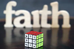 Wooden letters forming the word FAITH and Rubiks cube with religious symbols Wooden letters forming the word FAITH and Rubiks cube with religious symbols