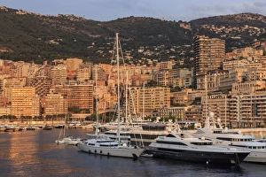 Yachts in the glamorous Port of Monaco (Port Hercules) at sunrise, from the sea, Monte Carlo Yachts in the glamorous Port of Monaco (Port Hercules) at sunrise, from the sea, Monte Carlo