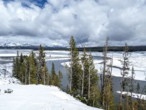 The Yellowstone River surrounded by snow-capped mountains, Yellowstone National Park The Yellowstone River surrounded by snow-capped mountains, Yellowstone National Park