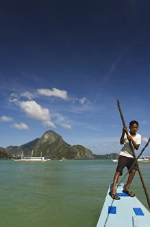 Young boy punting boat Young boy punting boat