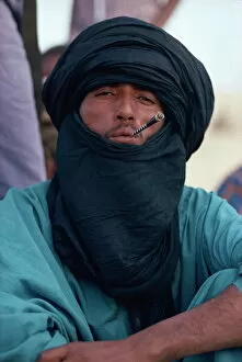 Mali Gallery: Young Tuareg man smoking small pipe and wearing headscarf, Timbuktu, Mali, West Africa, Africa