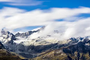 Zinalrothorn and Wellenkuppe mountains emerging from cumulus clouds, Valais Canton Zinalrothorn and Wellenkuppe mountains emerging from cumulus clouds, Valais Canton