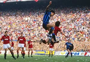 Images Dated 28th October 1984: Alessandro Altobelli and Mark Hateley compete in the air during the Milan Derby in 1984