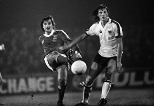 George Best passes the ball as he is challenged by Glenn Hoddle