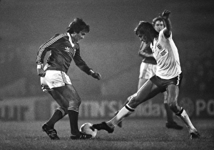 Glenn Hoddle attempts to tackle George Best