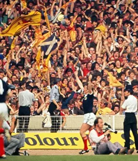 Images Dated 4th June 1977: Kenny Dalglish celebrates his goal in front of the Scotland fans at Wembley - 1977 British Home Championship