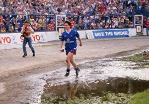 Images Dated 23rd March 2011: Kevin McAllister of Chelsea runs through the puddles with the Division Two trophy