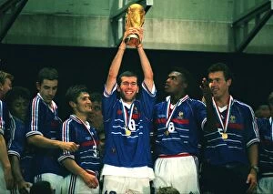 1998 France Gallery: Man of the Match Zinedine Zidane holds aloft the World Cup trophy