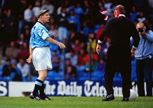 Norman Wisdom throws red cards at a referee