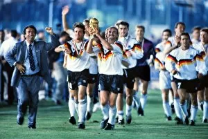 2010 South Africa Gallery: Rudi Voller celebrates with the World Cup trophy in 1990