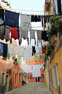 Chore Gallery: Clothes hanging on a washing line across a street on washday in Venice, Italy