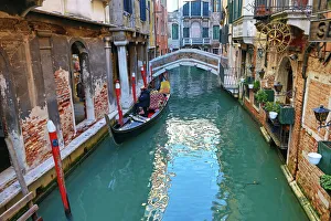 Deserted bridge over a canal with a gondola in Venice, Italy Deserted bridge over a canal with a gondola in Venice, Italy