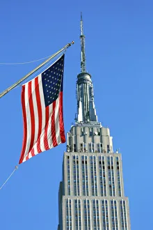 The Empire State Building and Stars and Stripes American flag, New York. America The Empire State Building and Stars and Stripes American flag, New York. America