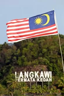 Images Dated 13th April 2015: Malaysian flag flying on the beach in Pantai Cenang, Langkawi, Malaysia